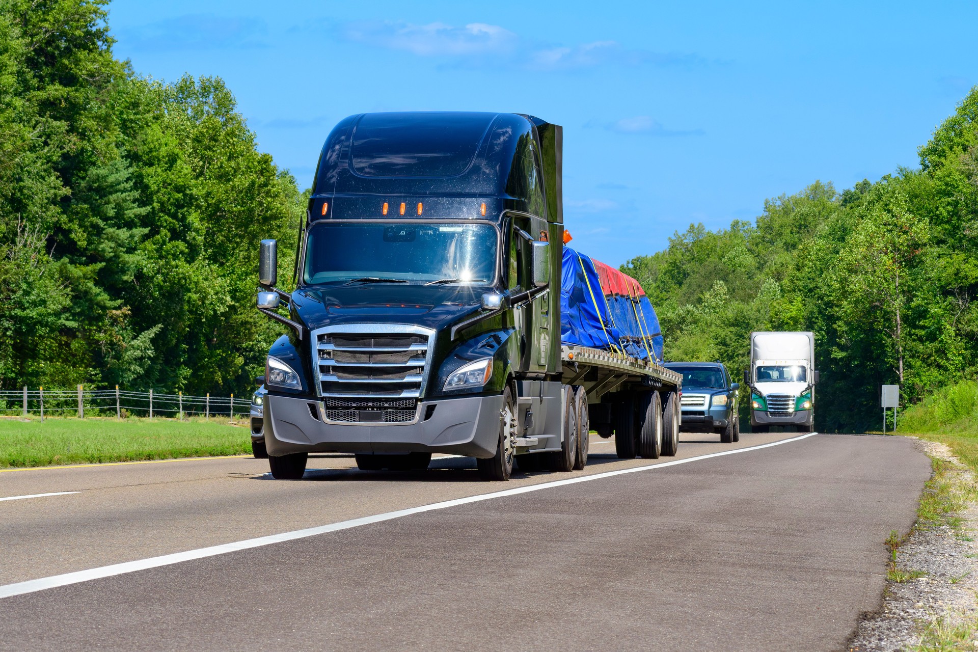 Flatbed Eighteen-Wheeler Semi With Load of Heavy Machinery